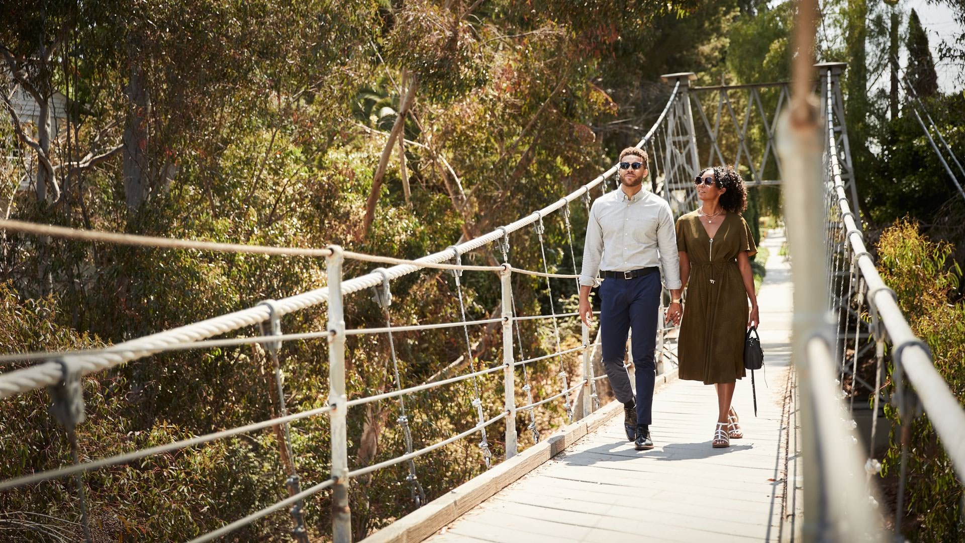 Couple walking on a suspended bridge 
